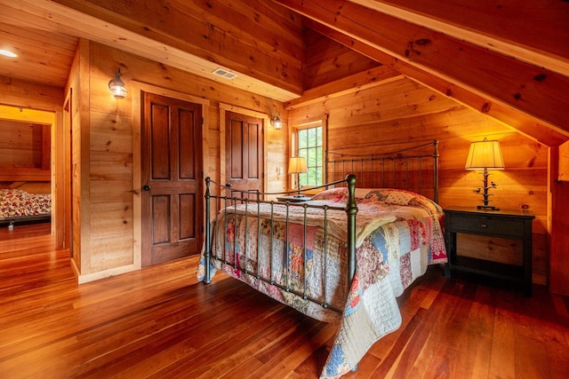 938 Stigers Rd, Andover, VT 05143 - bedroom with wooden walls, hardwood / wood-style flooring, and vaulted ceiling