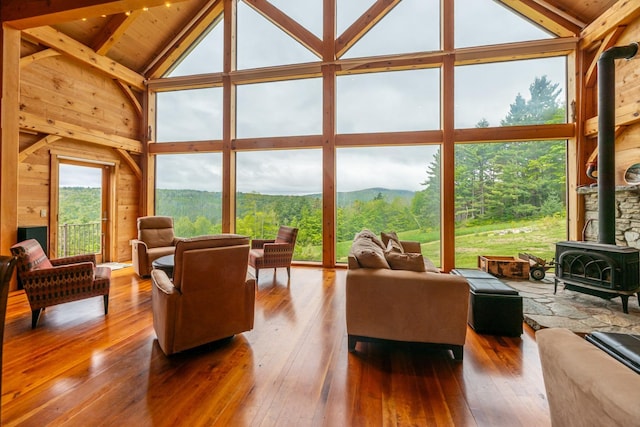 938 Stigers Rd, Andover, VT 05143 - living area featuring a wood stove, hardwood / wood-style floors, high vaulted ceiling, wood ceiling with exposed beams, and wooden walls
