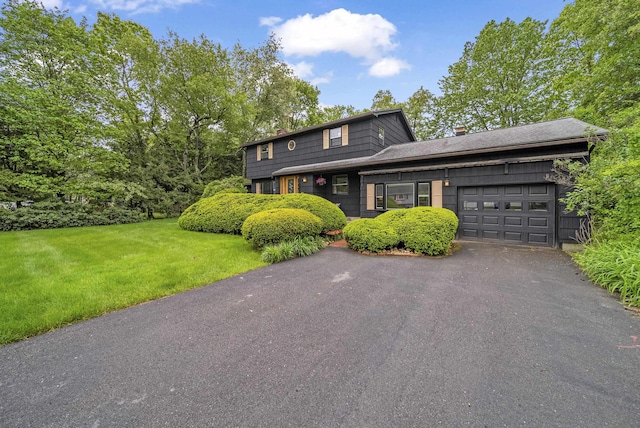 3 Timber Ln, Merrimack, NH 03054 - view of front of property with an attached garage, a front lawn, a chimney, and driveway