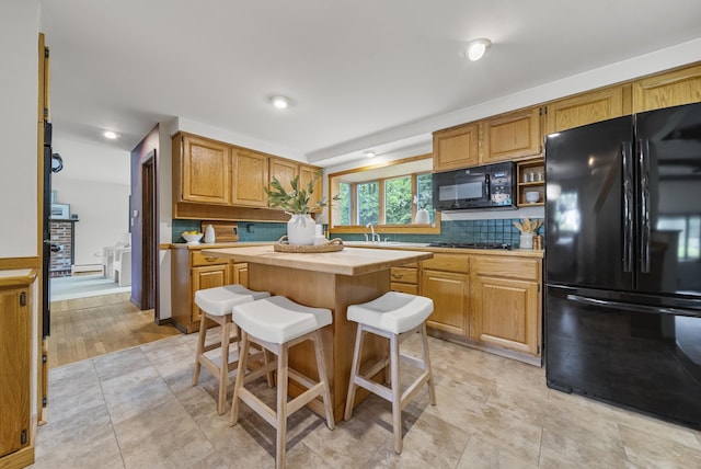 3 Timber Ln, Merrimack, NH 03054 - kitchen featuring black appliances, decorative backsplash, a center island, a sink, and open shelves