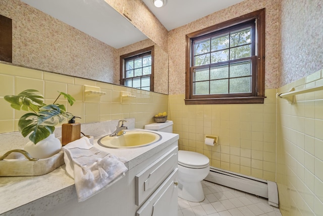 3 Timber Ln, Merrimack, NH 03054 - bathroom featuring a baseboard radiator, wallpapered walls, tile walls, tile patterned flooring, and vanity