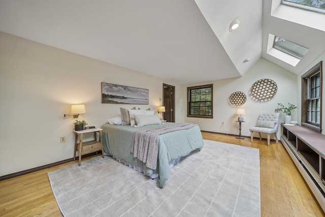3 Timber Ln, Merrimack, NH 03054 - bedroom with a baseboard radiator, a skylight, light wood-style floors, lofted ceiling, and baseboards