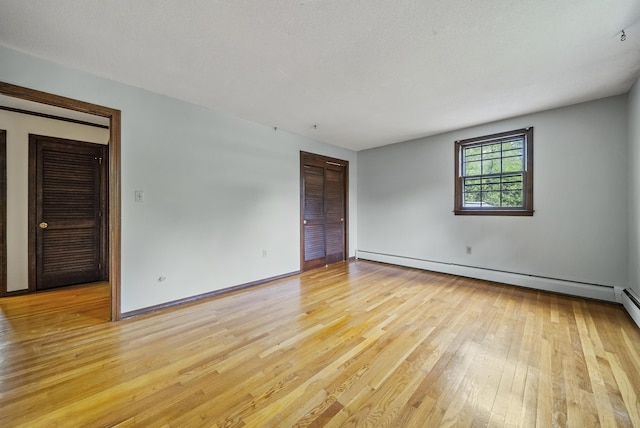 3 Timber Ln, Merrimack, NH 03054 - empty room with light wood-type flooring, baseboard heating, and baseboards
