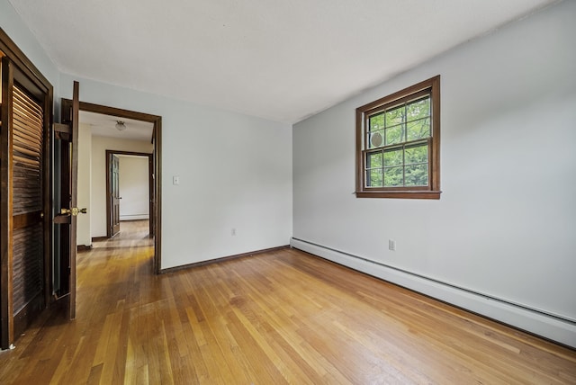 3 Timber Ln, Merrimack, NH 03054 - empty room featuring baseboard heating, hardwood / wood-style flooring, and baseboards