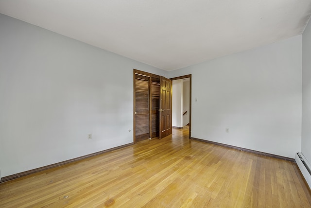 3 Timber Ln, Merrimack, NH 03054 - empty room with a baseboard radiator, light wood-style flooring, and baseboards