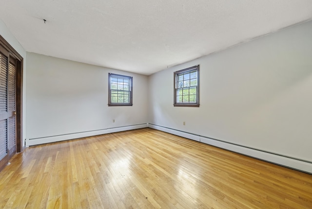 3 Timber Ln, Merrimack, NH 03054 - unfurnished room featuring wood-type flooring, a baseboard heating unit, and baseboards