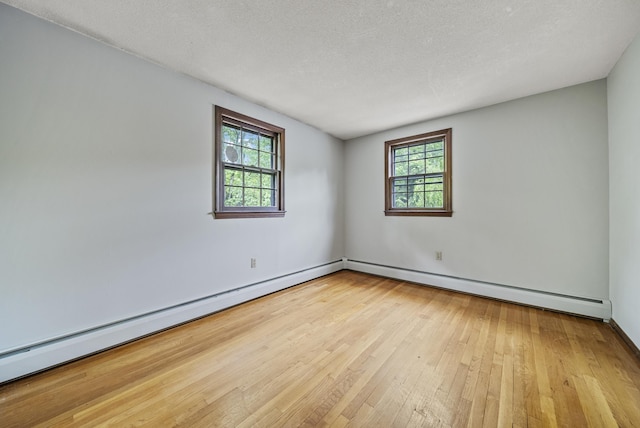 3 Timber Ln, Merrimack, NH 03054 - empty room featuring wood-type flooring, baseboard heating, a textured ceiling, and baseboards