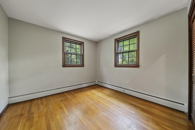 3 Timber Ln, Merrimack, NH 03054 - unfurnished room featuring plenty of natural light, light wood-type flooring, and a baseboard heating unit