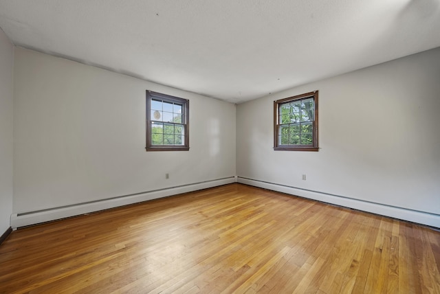 3 Timber Ln, Merrimack, NH 03054 - unfurnished room with healthy amount of natural light, hardwood / wood-style flooring, and a baseboard heating unit
