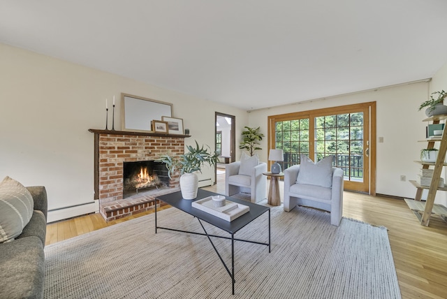 3 Timber Ln, Merrimack, NH 03054 - living area with a baseboard heating unit, wood finished floors, and a fireplace