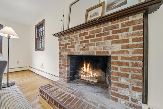 3 Timber Ln, Merrimack, NH 03054 - detailed view of a brick fireplace, a baseboard radiator, and wood finished floors
