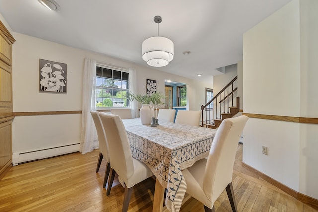 3 Timber Ln, Merrimack, NH 03054 - dining space with a baseboard heating unit, light wood-style floors, baseboards, and stairs