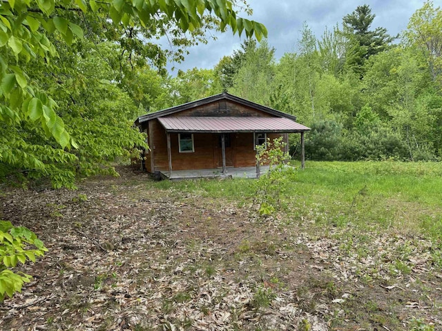 149 John Hodgdon Rd, Ossipee, NH 03864 - view of home's exterior with metal roof and a forest view