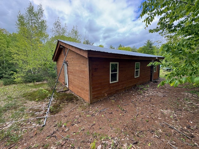 149 John Hodgdon Rd, Ossipee, NH 03864 - view of side of home featuring metal roof and an outdoor structure