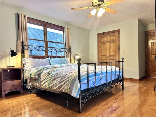 2522 Number 12 Rd, Newport City, VT 05857 - bedroom with light wood-style floors, baseboards, ceiling fan, and a textured ceiling