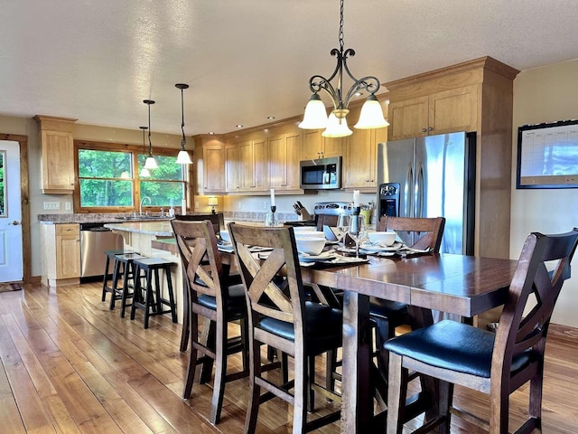 2522 Number 12 Rd, Newport City, VT 05857 - dining space with light wood-style floors, a chandelier, and a textured ceiling