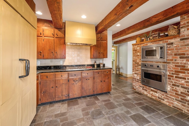 74 Bartlett Rd, Barnstead, NH 03225 - kitchen featuring stainless steel appliances, wall chimney range hood, stone tile floors, dark countertops, and decorative backsplash