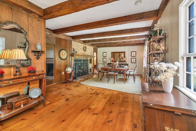 74 Bartlett Rd, Barnstead, NH 03225 - dining area with hardwood / wood-style floors, beam ceiling, a large fireplace, and wood walls