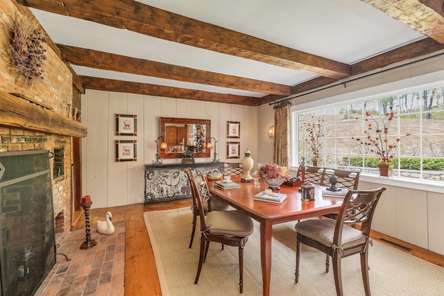 74 Bartlett Rd, Barnstead, NH 03225 - dining room featuring beamed ceiling, wood finished floors, and a brick fireplace
