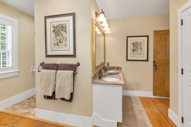 74 Bartlett Rd, Barnstead, NH 03225 - bathroom featuring double vanity, baseboards, and wood finished floors