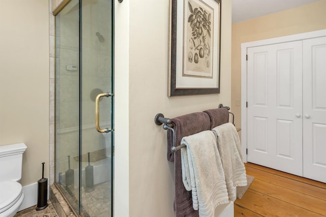 74 Bartlett Rd, Barnstead, NH 03225 - bathroom featuring toilet, a stall shower, and wood-type flooring
