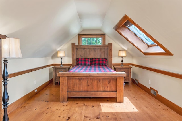 74 Bartlett Rd, Barnstead, NH 03225 - bedroom featuring a skylight, lofted ceiling, light wood-type flooring, and baseboards