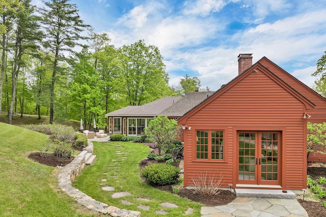 74 Bartlett Rd, Barnstead, NH 03225 - back of house featuring a chimney, a lawn, french doors, and roof with shingles