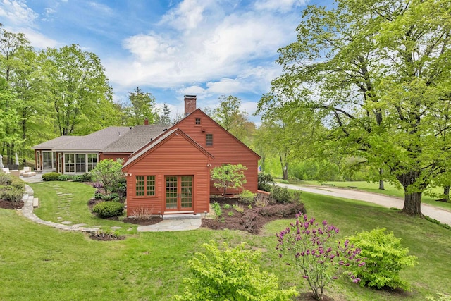 74 Bartlett Rd, Barnstead, NH 03225 - rear view of house with a chimney, a yard, and french doors