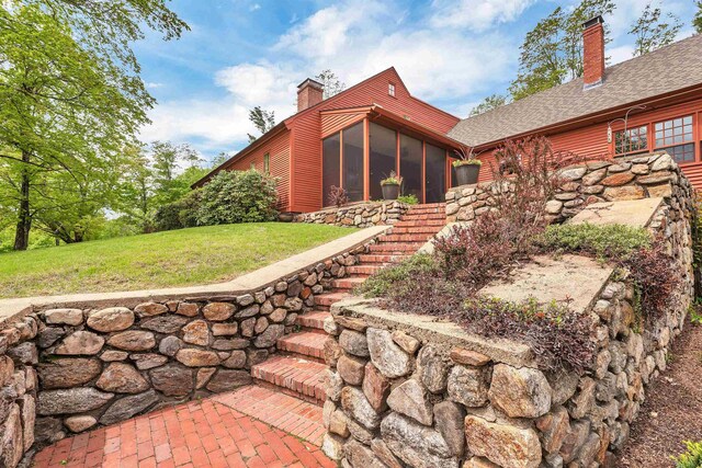 74 Bartlett Rd, Barnstead, NH 03225 - rear view of property with a chimney, a sunroom, a lawn, stairway, and roof with shingles