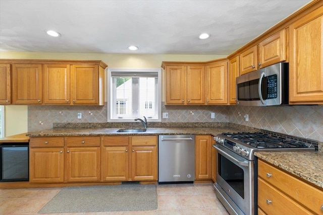 10 Hadleigh Rd, Windham, NH 03087 - kitchen featuring stainless steel appliances, beverage cooler, a sink, brown cabinetry, and recessed lighting