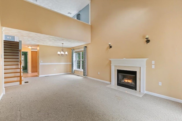 10 Hadleigh Rd, Windham, NH 03087 - unfurnished living room with carpet flooring, a chandelier, a fireplace with flush hearth, and stairway