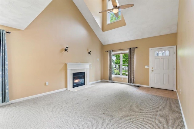 10 Hadleigh Rd, Windham, NH 03087 - unfurnished living room featuring high vaulted ceiling, ceiling fan, baseboards, a fireplace with flush hearth, and carpet flooring