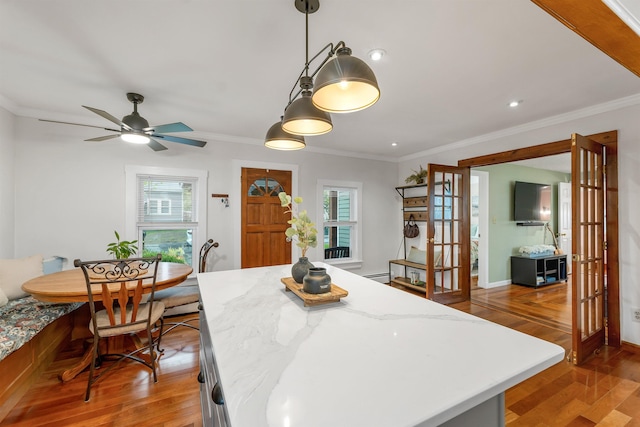 47 Foch St, Manchester, NH 03104 - dining space featuring light wood-style floors, plenty of natural light, ornamental molding, french doors, and ceiling fan