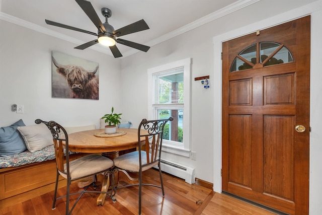 47 Foch St, Manchester, NH 03104 - dining space featuring a baseboard heating unit, light wood-style floors, crown molding, a ceiling fan, and baseboards
