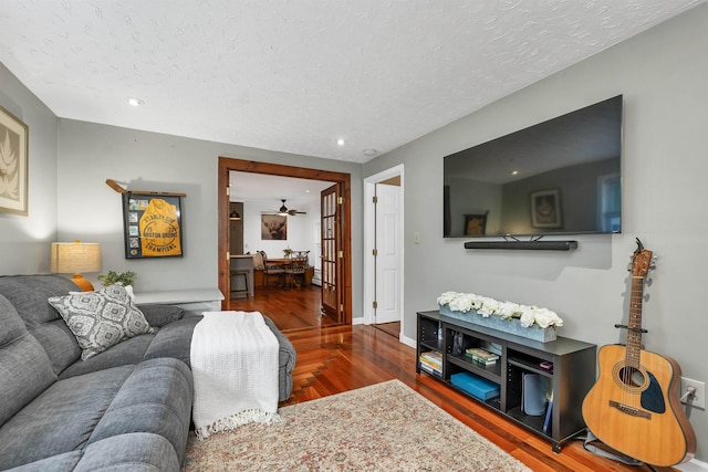47 Foch St, Manchester, NH 03104 - living room with wood finished floors, a textured ceiling, recessed lighting, and baseboards