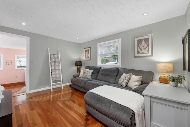 47 Foch St, Manchester, NH 03104 - living area featuring wood finished floors, baseboards, a textured ceiling, and recessed lighting