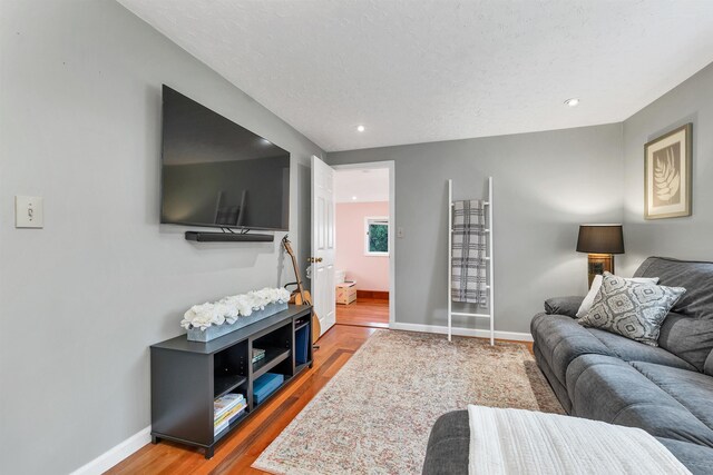 47 Foch St, Manchester, NH 03104 - living area with wood finished floors, baseboards, and recessed lighting