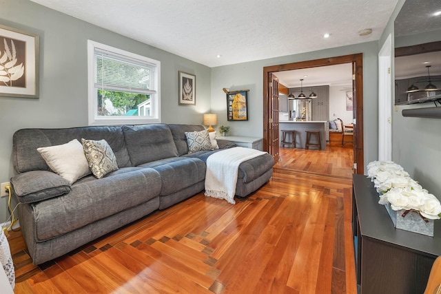 47 Foch St, Manchester, NH 03104 - living room with wood finished floors and a textured ceiling