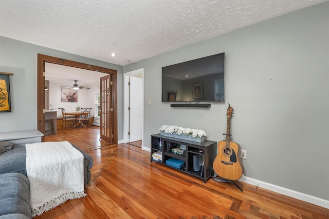 47 Foch St, Manchester, NH 03104 - living room featuring wood finished floors, baseboards, a textured ceiling, and recessed lighting
