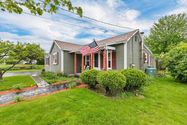 47 Foch St, Manchester, NH 03104 - view of property exterior with a lawn and a shingled roof