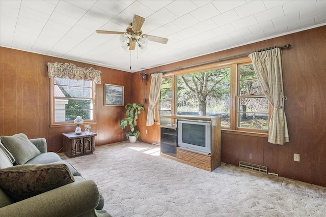 129 Camp Kiniya Rd, Colchester, VT 05446 - living area featuring carpet, wooden walls, and a ceiling fan