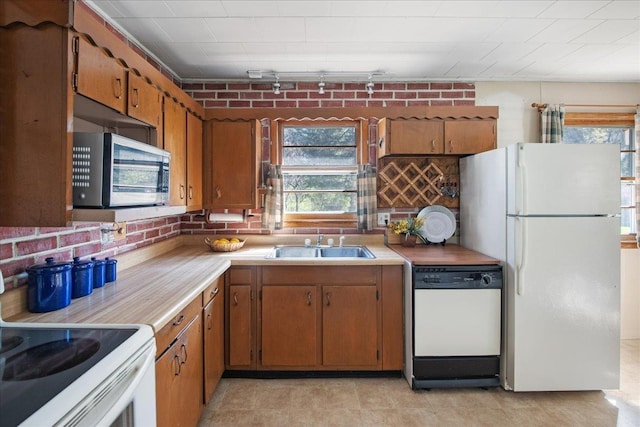 129 Camp Kiniya Rd, Colchester, VT 05446 - kitchen with white appliances, a sink, healthy amount of natural light, and light countertops