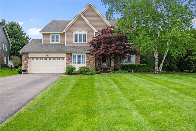 26 Pinnacle Dr, South Burlington, VT 05403 - view of front of home with asphalt driveway, stone siding, a front lawn, a shingled roof, and an attached garage