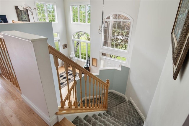 26 Pinnacle Dr, South Burlington, VT 05403 - staircase with baseboards, a high ceiling, and wood finished floors