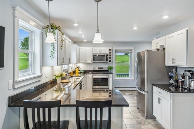 3352 Watertower Rd, Berkshire, VT 05450 - kitchen with stainless steel appliances, a sink, healthy amount of natural light, a peninsula, and recessed lighting