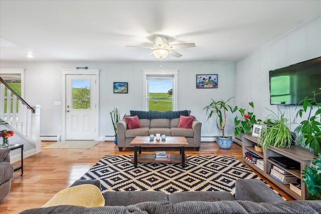 3352 Watertower Rd, Berkshire, VT 05450 - living area featuring plenty of natural light, stairs, a baseboard heating unit, and a ceiling fan