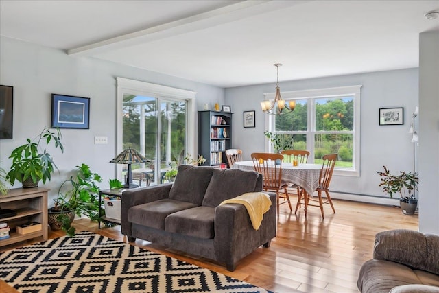 3352 Watertower Rd, Berkshire, VT 05450 - living room with a chandelier, a baseboard radiator, and light wood finished floors