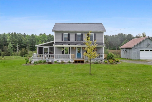3352 Watertower Rd, Berkshire, VT 05450 - view of front of house featuring an outdoor structure, a front yard, a detached garage, a porch, and metal roof