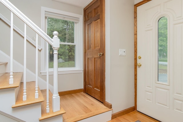27 Grafton Dr, Bedford, NH 03110 - foyer with baseboards, light wood finished floors, and stairs