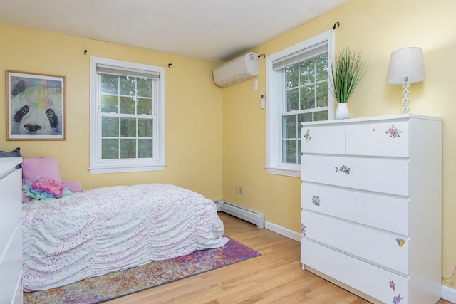 27 Grafton Dr, Bedford, NH 03110 - bedroom with a wall mounted air conditioner, wood finished floors, a baseboard radiator, and baseboards